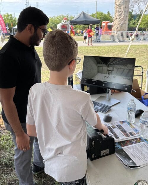 child demonstrates crane simulator