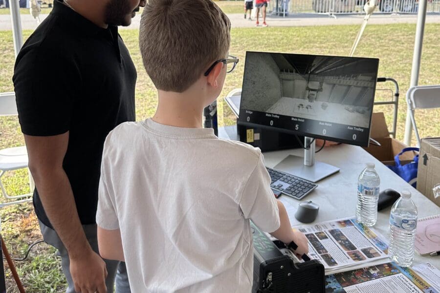 child demonstrates crane simulator