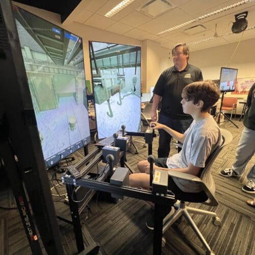 student demonstrating crane simulator