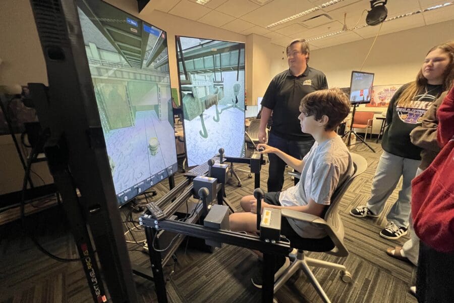 student demonstrating crane simulator