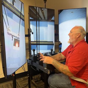 Man smiling while using crane simulation