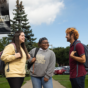 Three students stand outside on the PNW Hammond Campus.