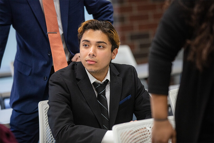 Student in business suit in classroom