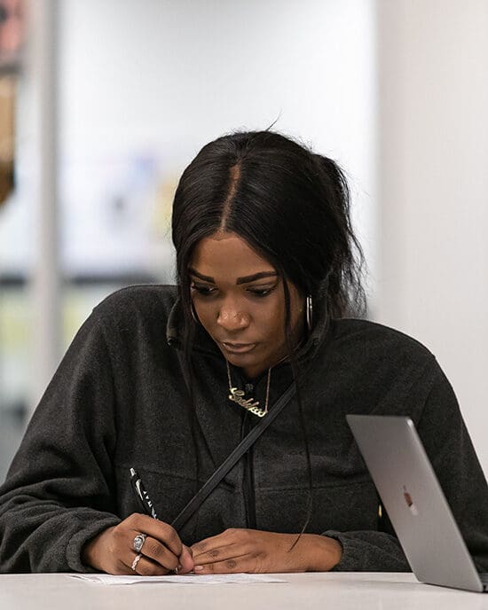 Student taking notes in classroom