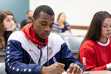 Male student looking at work