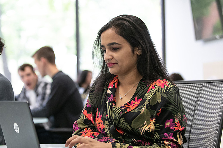 A PNW student works on a laptop