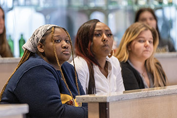 Students listen in a Hospitality and Tourism Management classroom