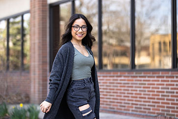 A PNW student stands outdoors