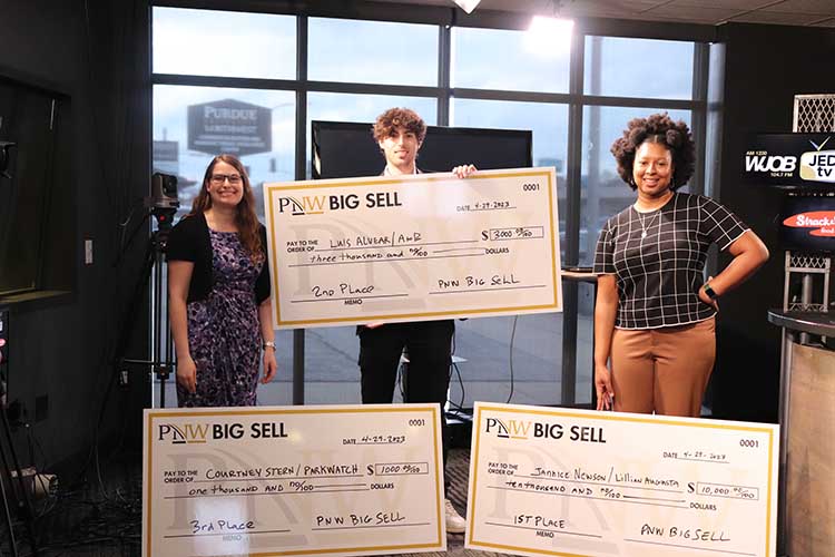 From right to left, the PNW Big Sell winners, in order from first to third, included Jannice Newson, Luis Alvear, and Courtney Stern. They are standing with their prize checks