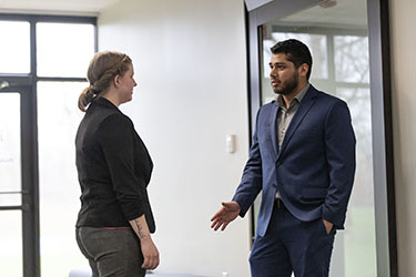 PNW Students in Professional Clothing Talk in a hallway