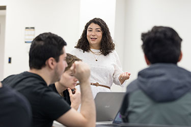 A professor stands in front of a class