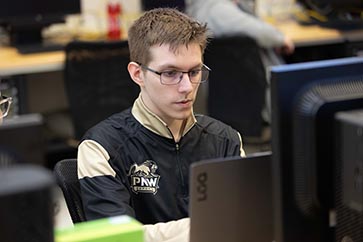 PNW student looking at the computer 363x242