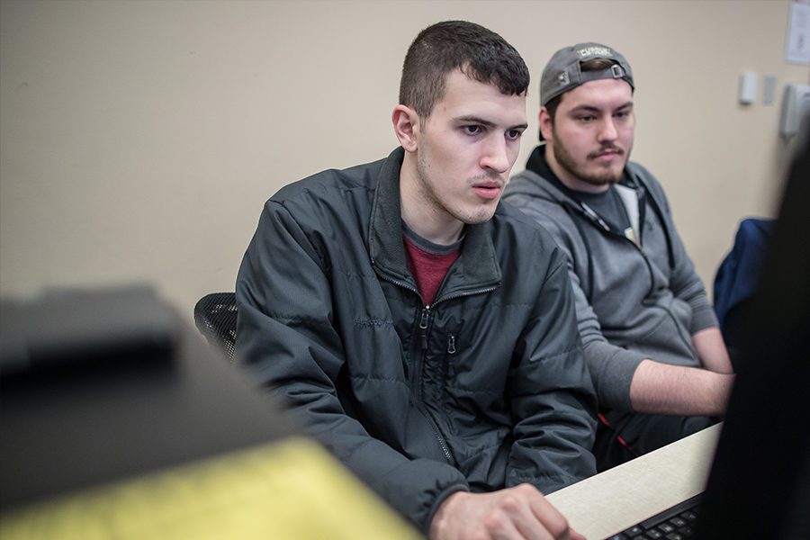 Students looking at a computer together