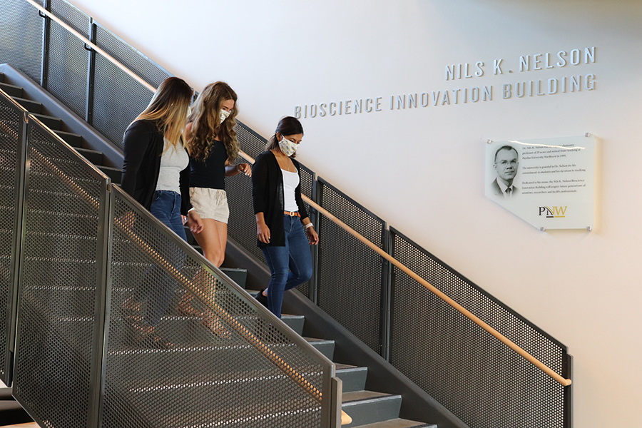 three female students walking down stairs in new nils k. nelson bioscience innovation building in hammond