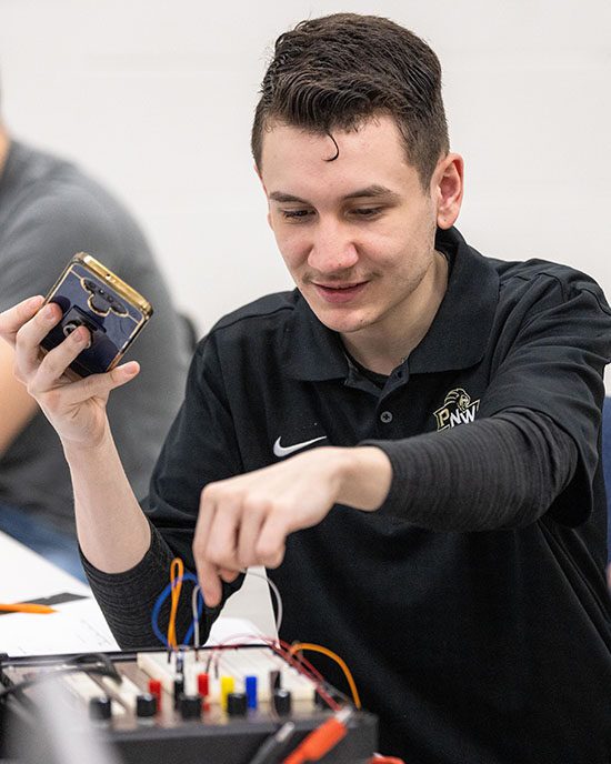 Student works on an electrical board