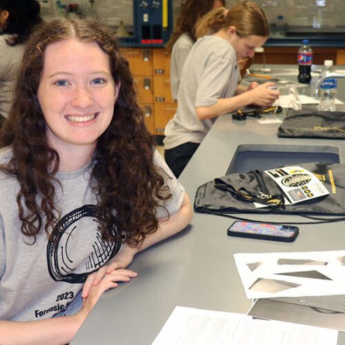 A student studies at a lab bench.