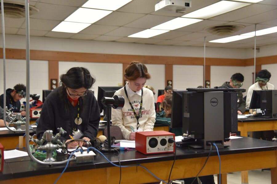 Students from Munster High School Science Olympiad and other high schools all gather inside a PNW lab as they work to solve a problem.