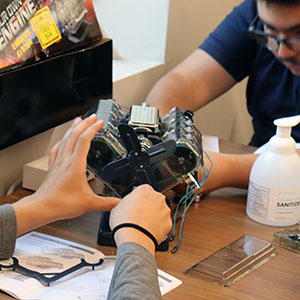 Camp participants work on an engine