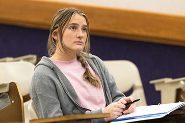 A PNW communication student listens in the classroom