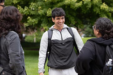 Four students talking with one another outside on the PNW campus 363x242