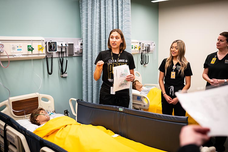 PNW Nursing faculty teaching students with the mannequin