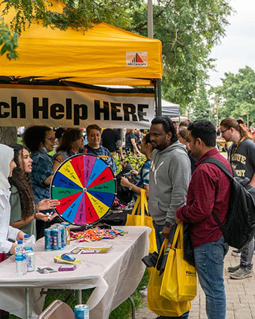 Students gather at an information table