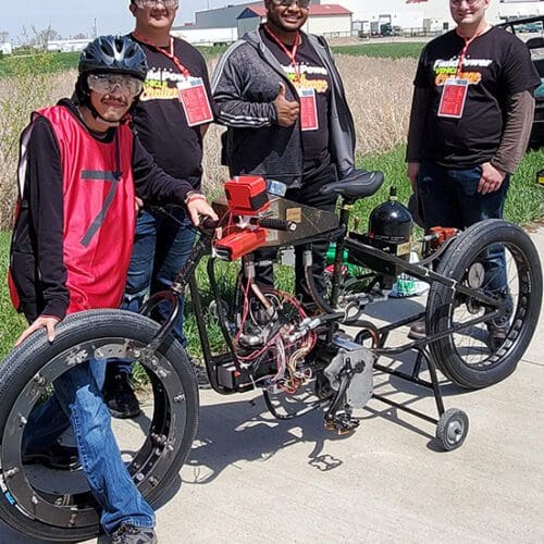 PNW Hydraulic Bike Team members Enoc Gutierrez, Diego Jimenez, Sam Torres, and Adam Hayman display their entry in the NFPA Fluid Power Vehicle Challenge..