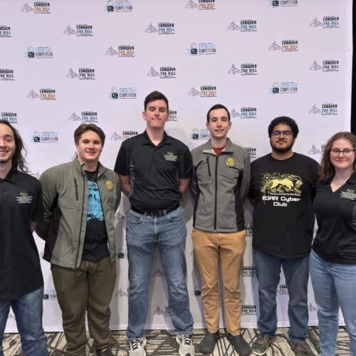 Five PNW students pose for photo at the Cyberforce Competition