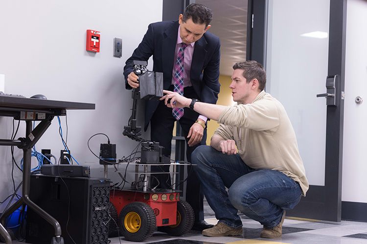 student and professor working on an assignment