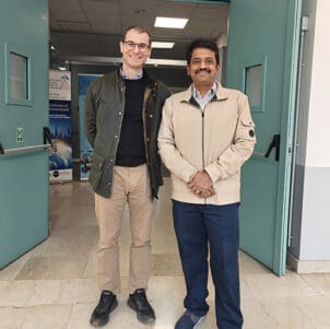 Alfonso Pagani and Magesh Chandramouli stand together in a doorway