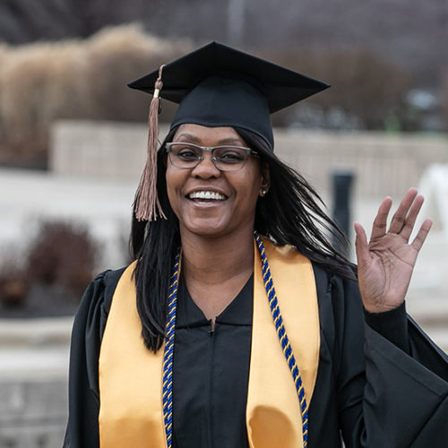 A student waves at PNW's commencement
