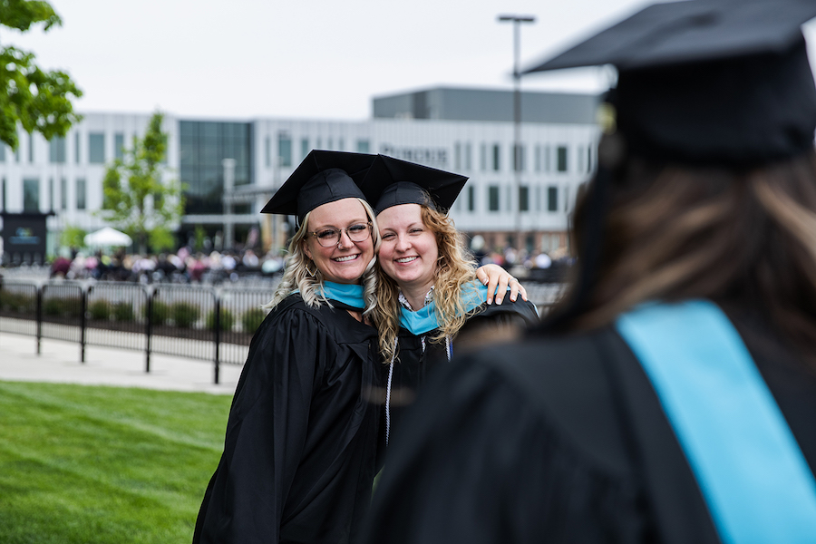 Grads are hugging at commencement.