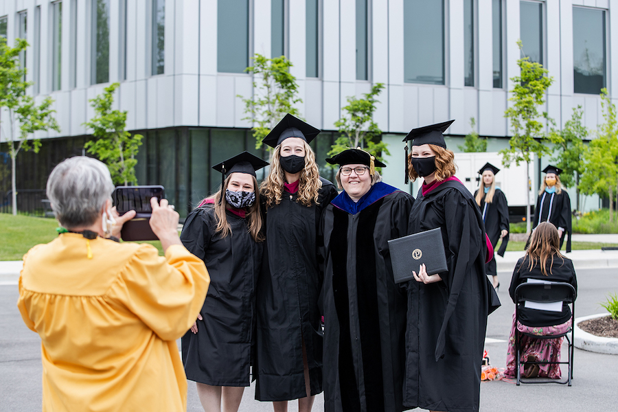 Grads posing for a pic at commencement.