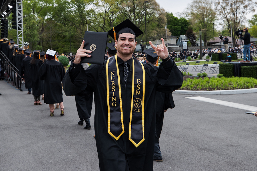 A graduate celebrates at spring 2021 commencement.