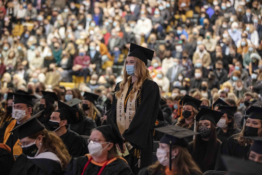 A student standing at commencement ceremony is pictured.