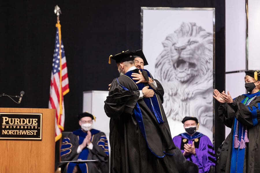 Grads hug each other.