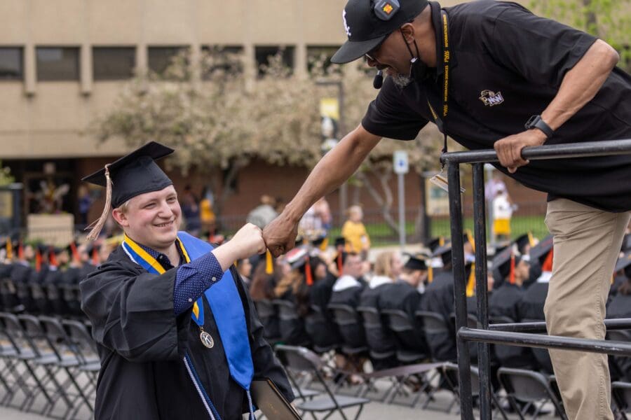 Graduate fist bump