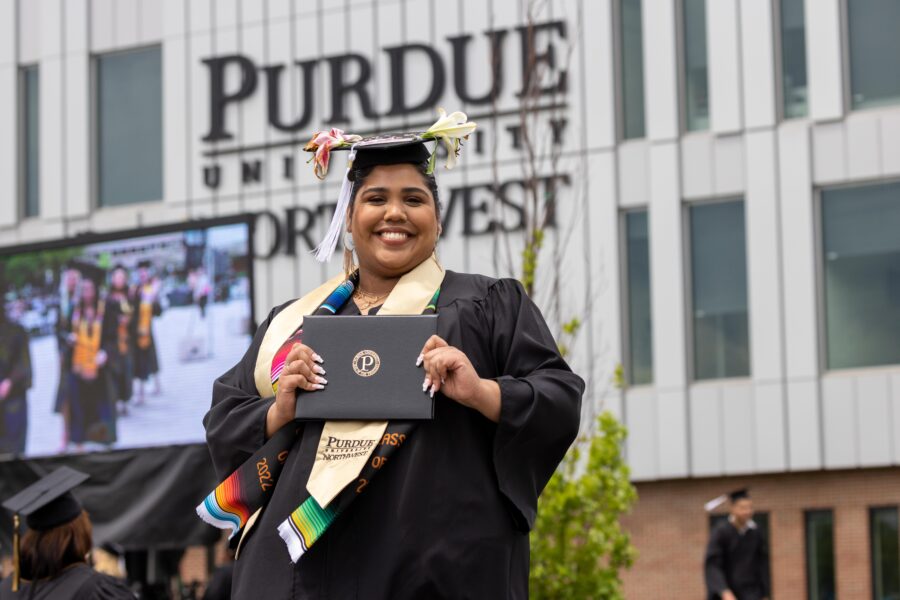 Graduate posing with degree