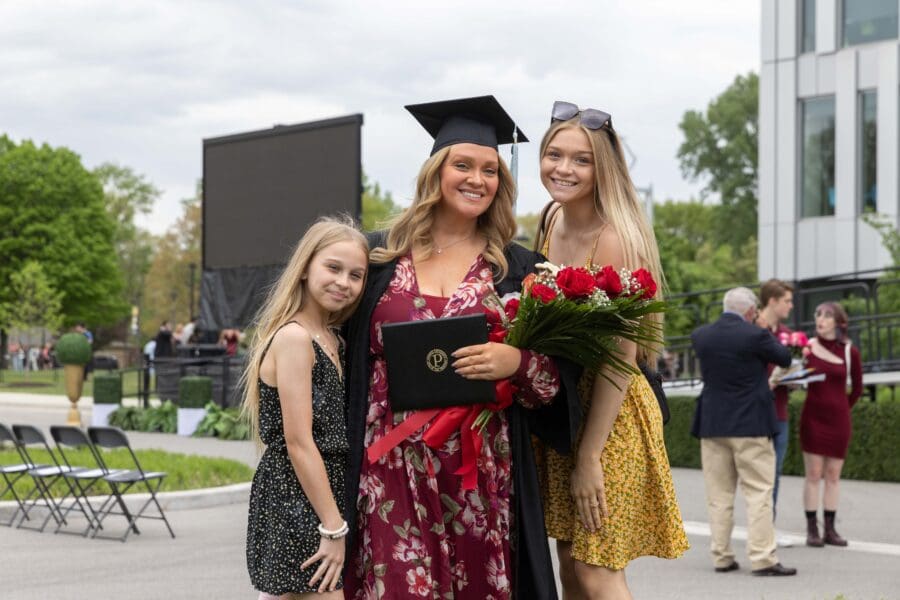 Graduate posing with family