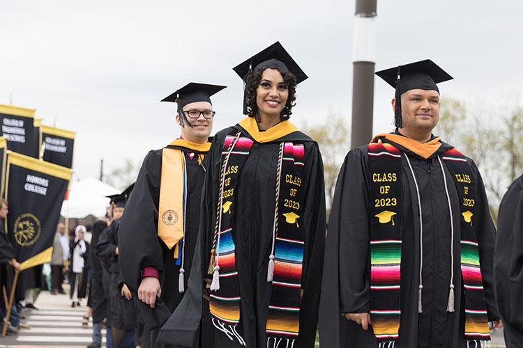 PNW graduates in class of 2023 stoles march up to receive their degrees.