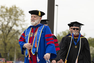 PNW Faculty parade in in academic regalia