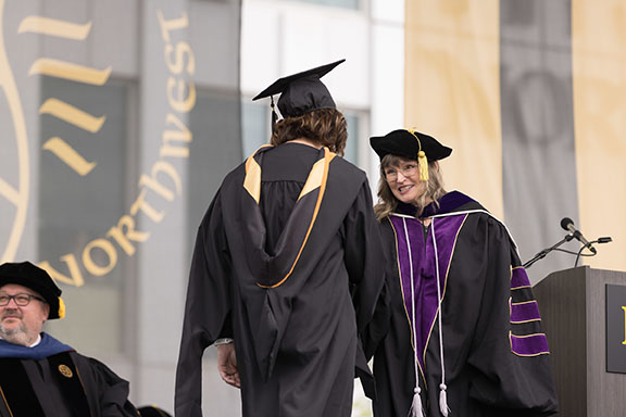 A PNW student receives her degree at Commencement.