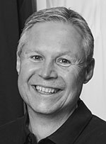 Black-and-white headshot of Joe Dudy