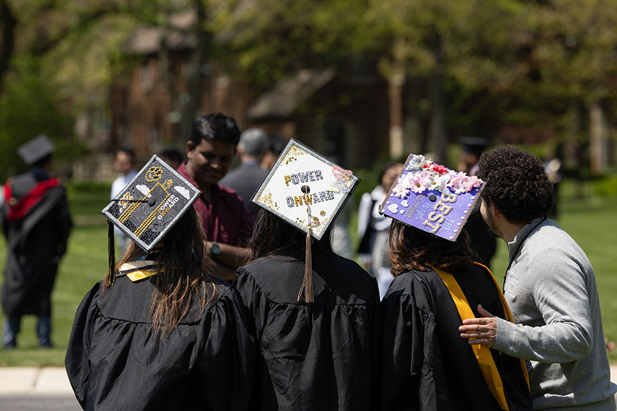 Graduates pose together with a staff member