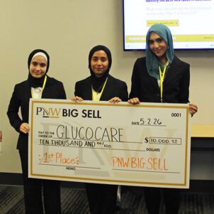 The Big Sell first place winner poses with a large check.