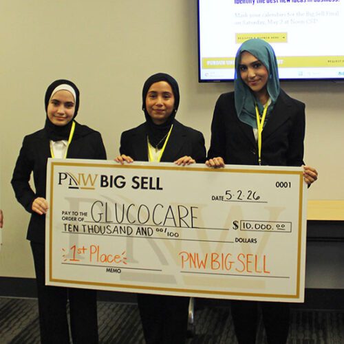 The Big Sell first place winner poses with a large check.