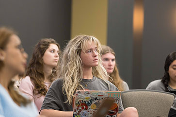 Students sit in a classroom.