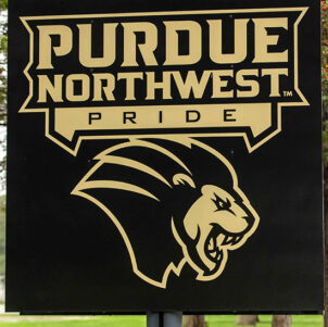A sign with the athletics logo and Purdue Northwest Pride
