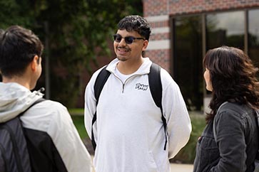 Three PNW students talking outside on campus 363x242