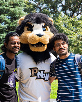 Two students taking a photo with Leo the Lion